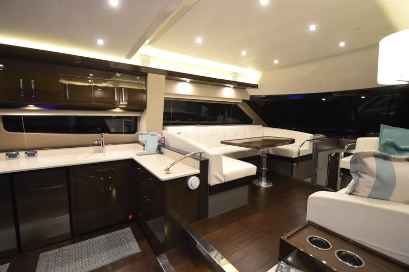 Play Craft Yacht Photos Pics Luxurious interior of 2018 Carver C52 Flybridge yacht with modern kitchen and seating area.