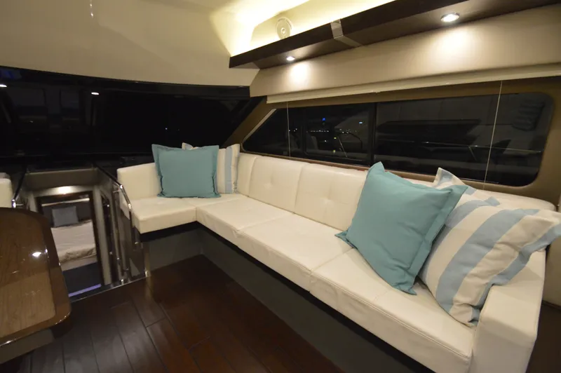 Play Craft Yacht Photos Pics Luxurious interior of 2018 Carver C52 Flybridge yacht with elegant seating and cushions.