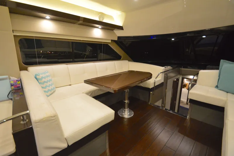 Play Craft Yacht Photos Pics Luxurious interior of 2018 Carver C52 Flybridge yacht with elegant seating and wooden flooring.