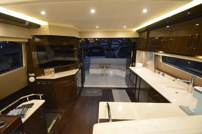 Play Craft Yacht Photos Pics Luxurious interior of 2018 Carver C52 Flybridge yacht with modern kitchen and entertainment area.