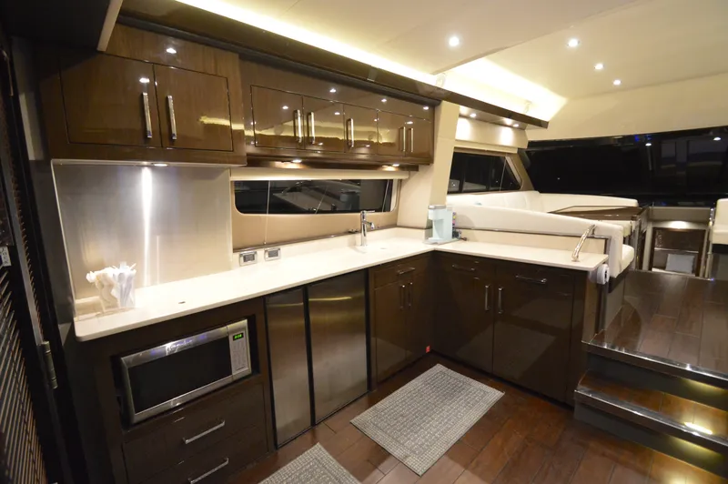 Play Craft Yacht Photos Pics Luxurious kitchen interior of 2018 Carver C52 Flybridge yacht with modern amenities.