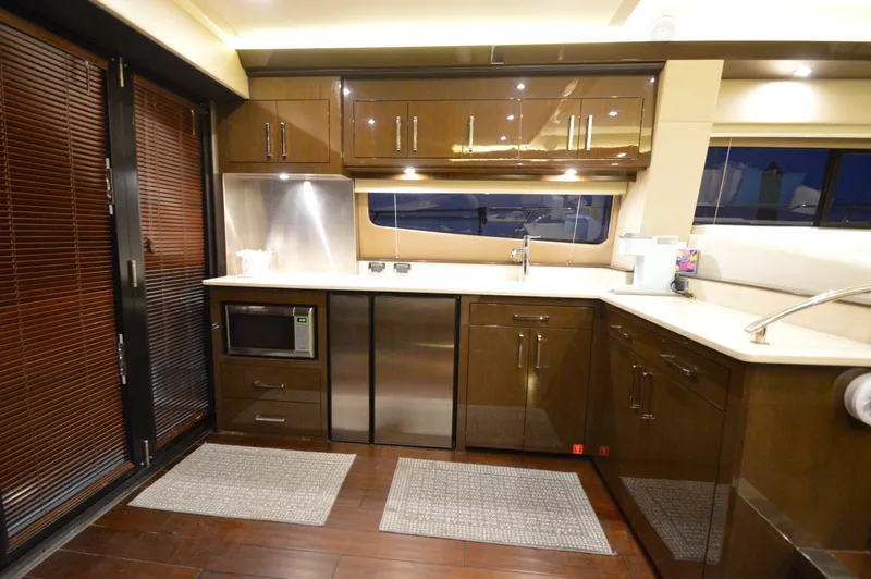 Play Craft Yacht Photos Pics Luxurious kitchen interior of 2018 Carver C52 Flybridge yacht with modern appliances and sleek design.