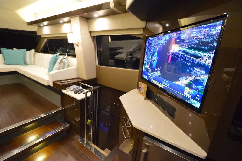 Play Craft Yacht Photos Pics Luxurious interior of 2018 Carver C52 Flybridge yacht with TV and seating area.