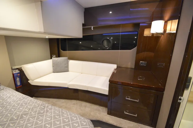 Play Craft Yacht Photos Pics Luxurious interior of 2018 Carver C52 Flybridge yacht with white sofa and wooden cabinetry.
