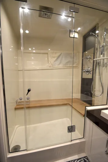 Play Craft Yacht Photos Pics Luxurious shower in 2018 Carver C52 Flybridge yacht with glass door and wooden bench.