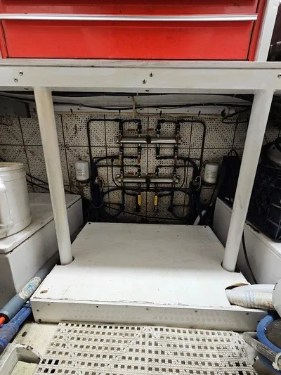  Yacht Photos Pics Engine room of a 1987 DeFever 53 POC yacht with visible piping and storage.