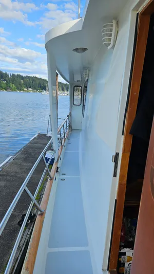  Yacht Photos Pics 1987 DeFever 53 POC yacht side deck with scenic waterfront view.