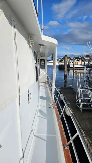 Yacht Photos Pics 1987 DeFever 53 POC yacht docked at marina under blue sky.