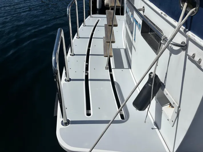  Yacht Photos Pics 1987 DeFever 53 POC yacht stern with railing and dock lines.