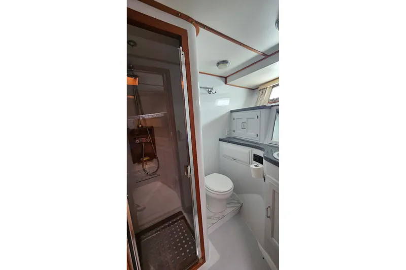  Yacht Photos Pics 1987 DeFever 53 POC yacht bathroom with shower, toilet, and sink.