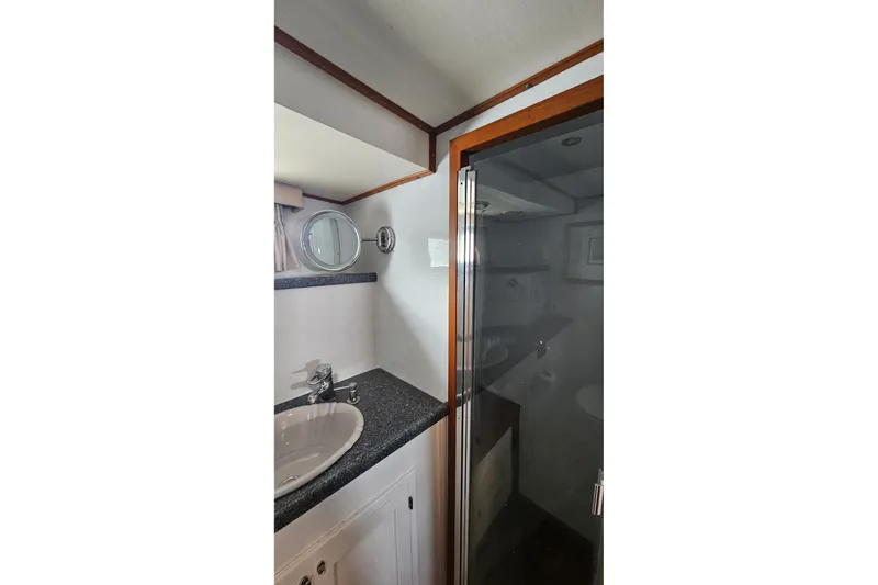  Yacht Photos Pics Bathroom interior of 1987 DeFever 53 POC yacht with sink and shower.