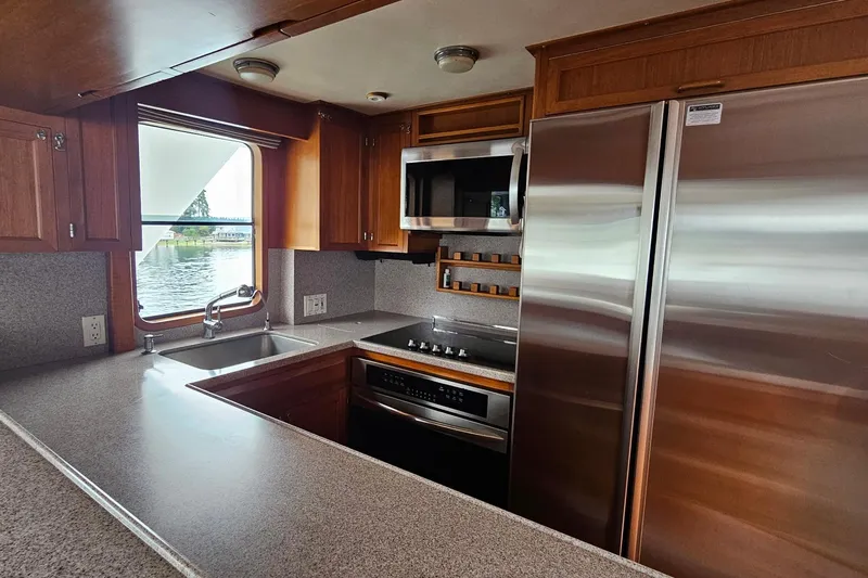  Yacht Photos Pics 1987 DeFever 53 POC yacht kitchen with modern appliances and waterfront view.