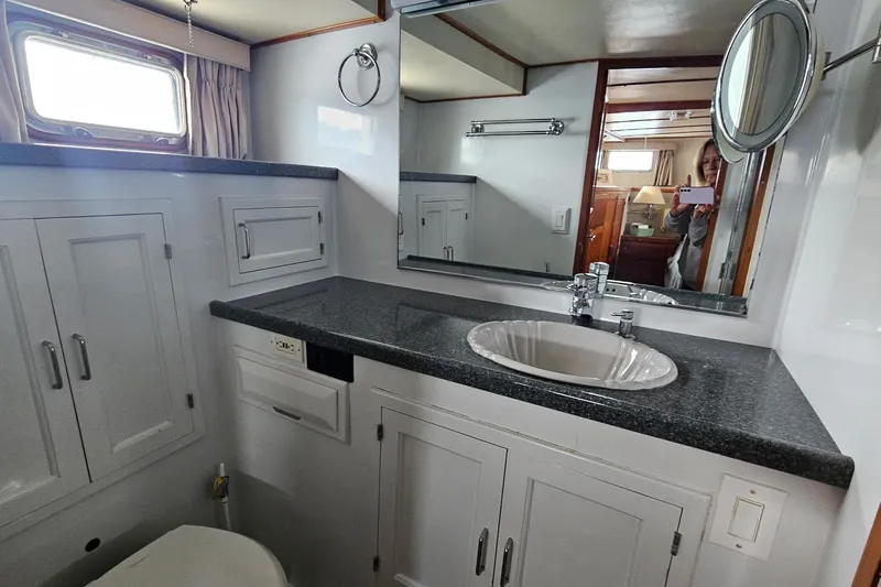  Yacht Photos Pics Bathroom interior of 1987 DeFever 53 POC yacht with sink and mirror.