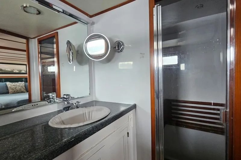  Yacht Photos Pics 1987 DeFever 53 POC yacht bathroom with sink, mirror, and shower.