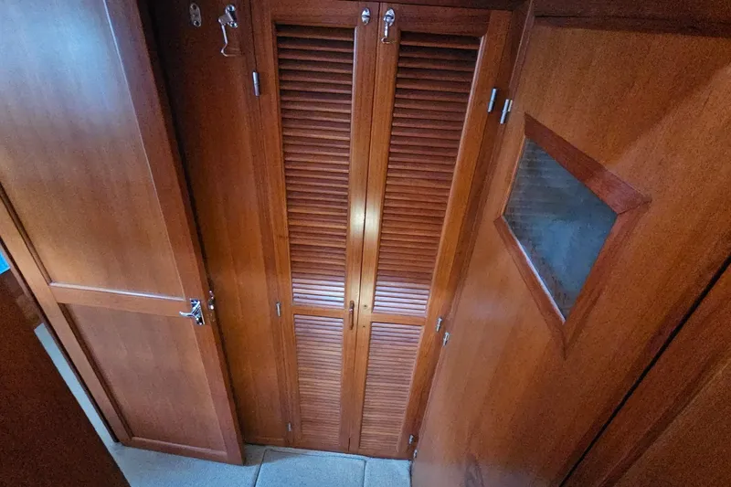  Yacht Photos Pics Wooden interior of 1987 DeFever 53 POC yacht, featuring louvered closet doors.