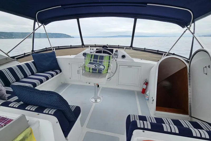  Yacht Photos Pics 1987 DeFever 53 POC yacht interior with striped seating and scenic ocean view.