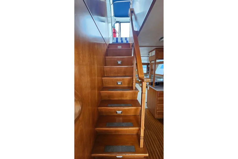  Yacht Photos Pics Wooden staircase inside 1987 DeFever 53 POC yacht, leading to upper deck.