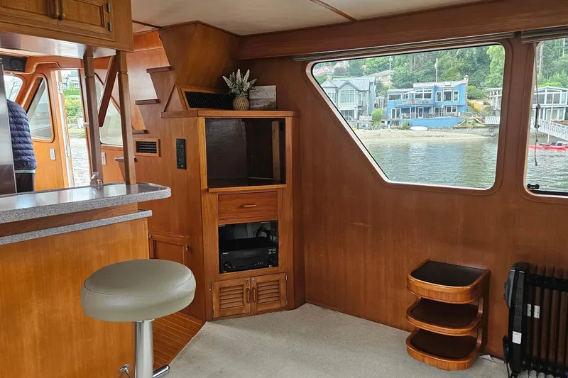  Yacht Photos Pics Interior of 1987 DeFever 53 POC yacht with wooden cabinetry and waterfront view.