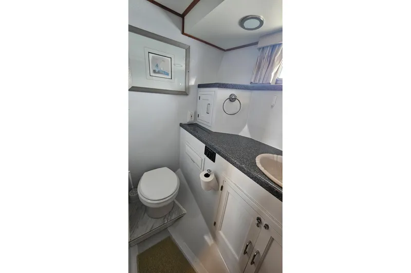  Yacht Photos Pics Bathroom interior of 1987 DeFever 53 POC yacht with modern fixtures and decor.