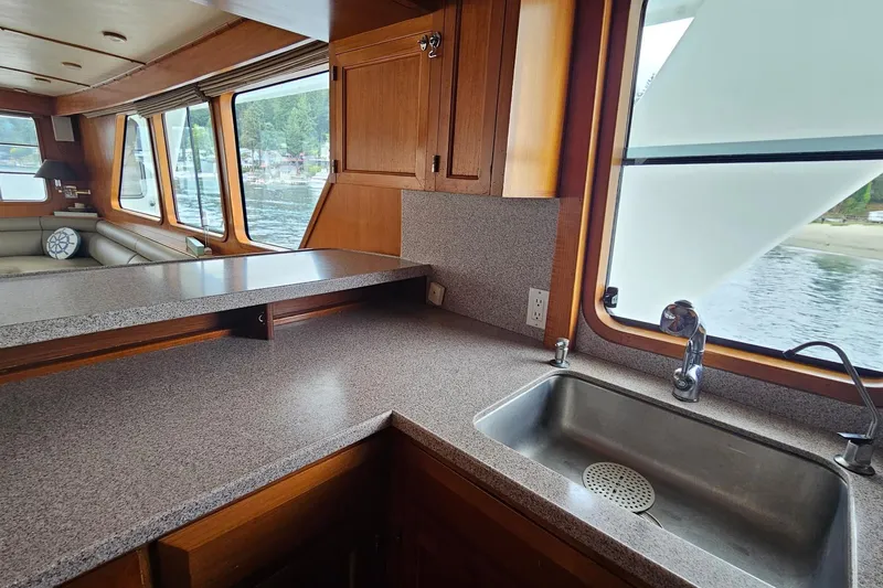  Yacht Photos Pics Interior of 1987 DeFever 53 POC yacht with kitchen sink and scenic window view.