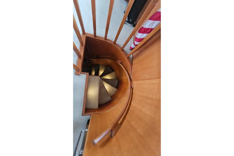  Yacht Photos Pics Curved wooden staircase inside 1987 DeFever 53 POC yacht.