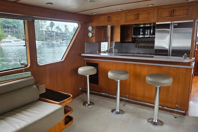  Yacht Photos Pics Interior of 1987 DeFever 53 POC yacht with bar stools and kitchen area.