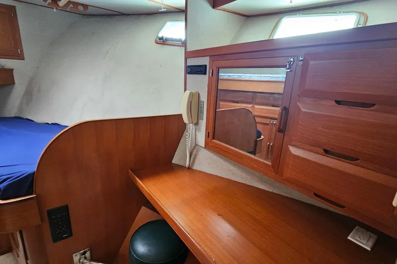  Yacht Photos Pics 1987 DeFever 53 POC cabin interior with wooden desk, mirror, and storage drawers.