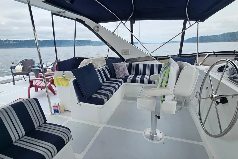  Yacht Photos Pics 1987 DeFever 53 POC yacht interior with striped seating and ocean view.