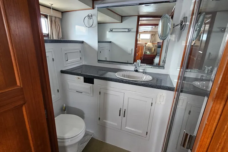  Yacht Photos Pics Bathroom interior of 1987 DeFever 53 POC yacht with sink, mirror, and toilet.