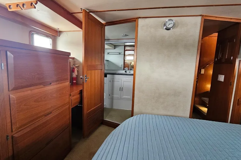  Yacht Photos Pics Interior of 1987 DeFever 53 POC yacht with wooden cabinetry and cozy bedroom.
