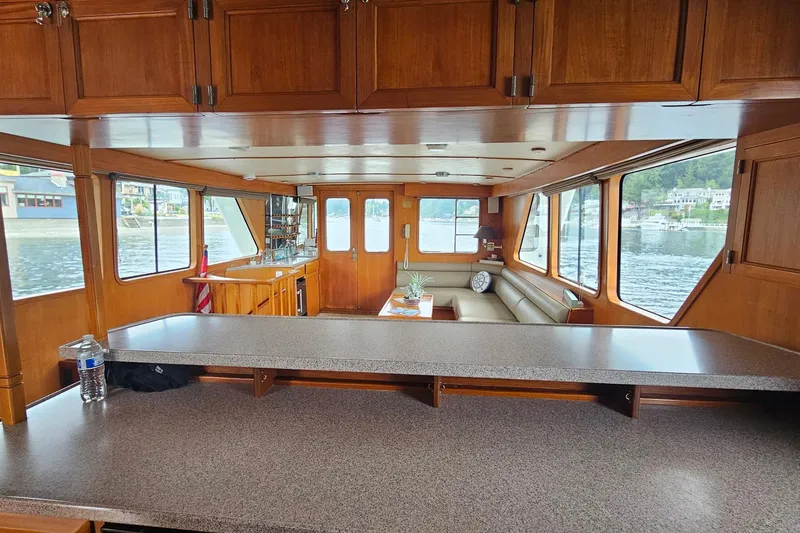  Yacht Photos Pics Interior of 1987 DeFever 53 POC yacht with spacious seating and large windows.