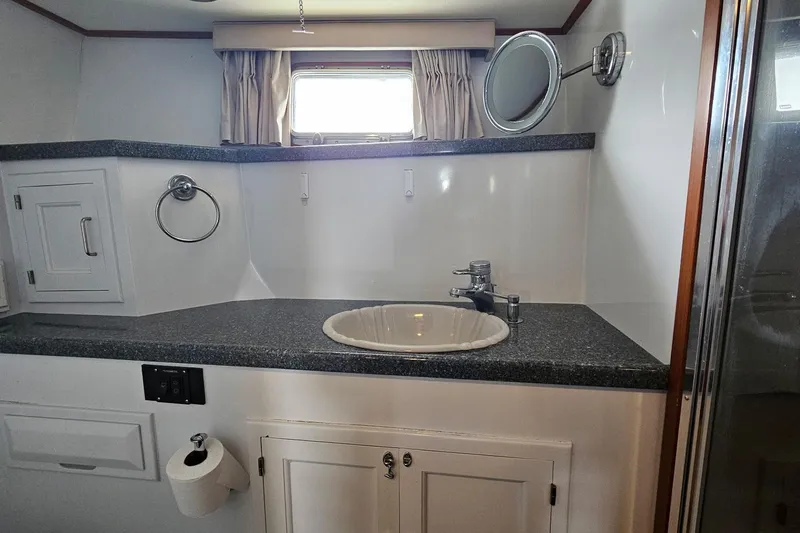  Yacht Photos Pics Bathroom interior of 1987 DeFever 53 POC yacht with sink and mirror.