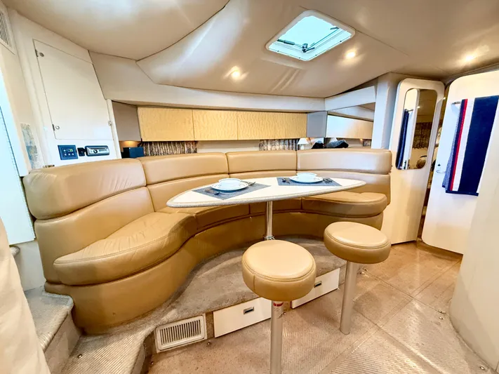 Formula 41pc Yacht Photos Pics 1999 Formula 41 PC yacht interior with curved seating, table, and skylight.