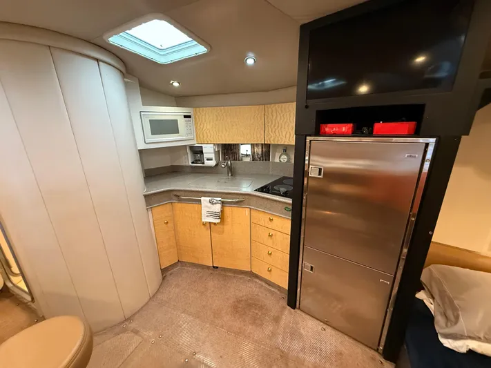 Formula 41pc Yacht Photos Pics 1999 Formula 41 PC yacht interior with kitchenette, microwave, and stainless steel fridge.