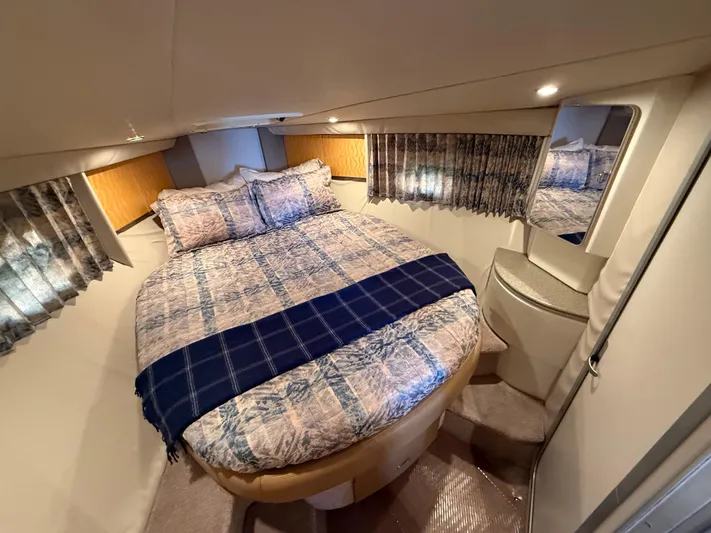 Formula 41pc Yacht Photos Pics 1999 Formula 41 PC yacht cabin with cozy bed, patterned bedding, and elegant decor.