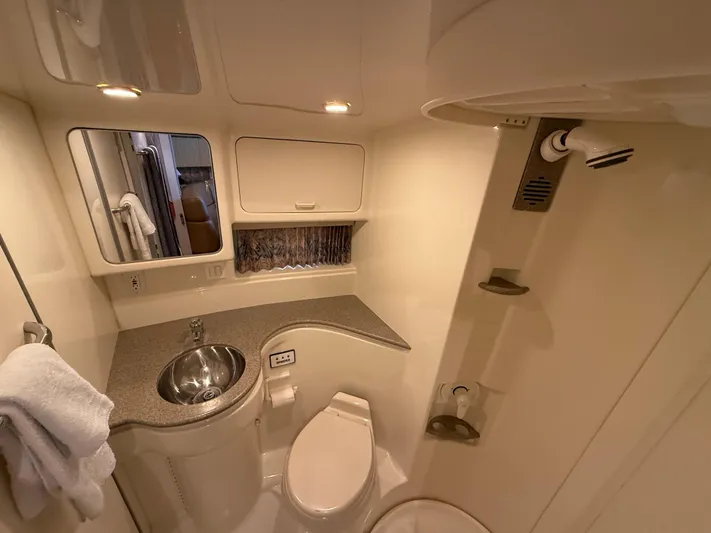 Formula 41pc Yacht Photos Pics 1999 Formula 41 PC yacht bathroom with sink, toilet, and shower in compact design.