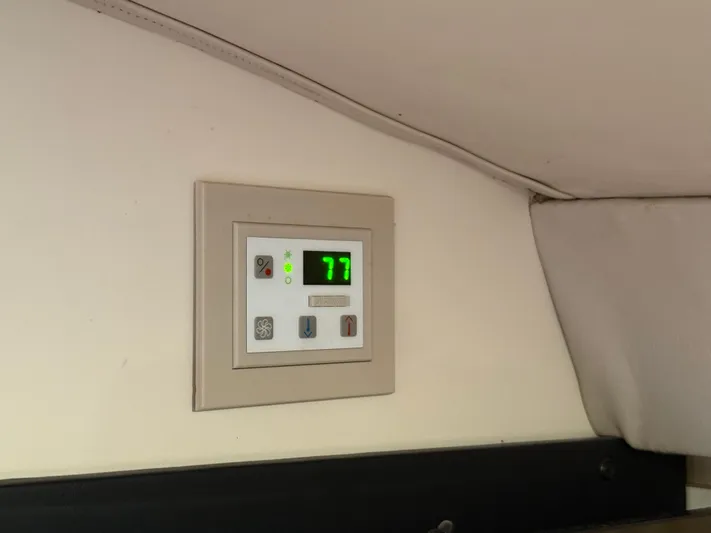 Formula 41pc Yacht Photos Pics Control panel inside a 1999 Formula 41 PC boat, displaying temperature at 77 degrees.