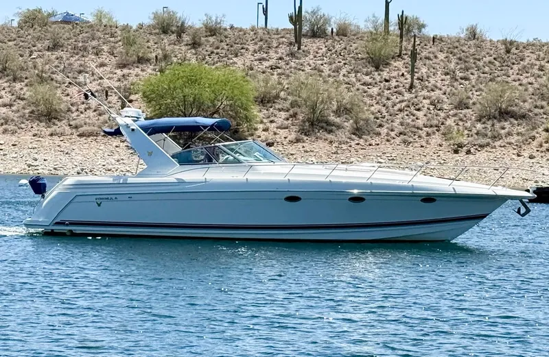 Formula 41pc Yacht Photos Pics 1999 Formula 41 PC boat cruising on a lake with desert landscape background.