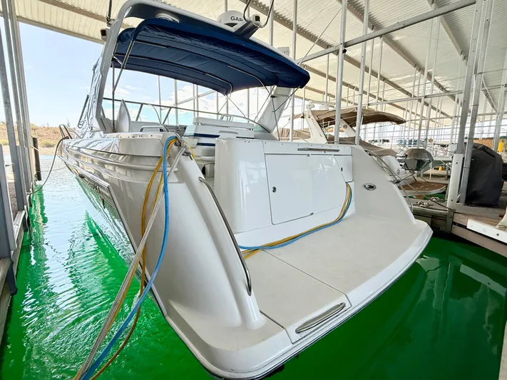 Formula 41pc Yacht Photos Pics 1999 Formula 41 PC yacht docked in marina, featuring sleek design and blue canopy.