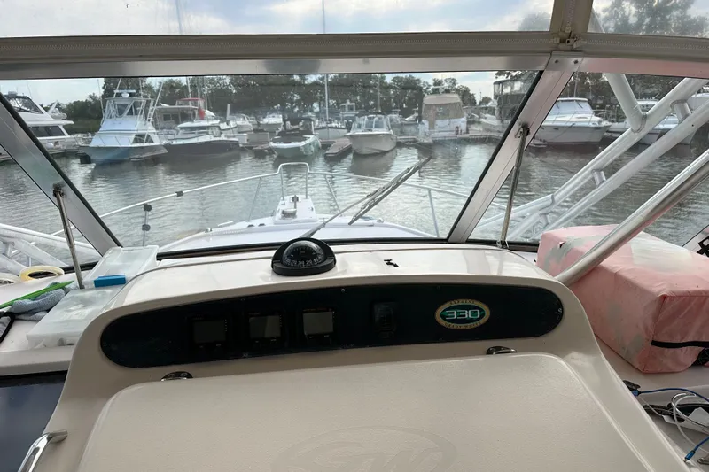 Triple Threat Yacht Photos Pics 2008 Grady-White Express 330 boat dashboard view in marina setting.