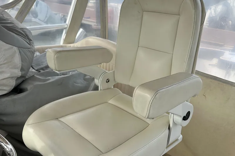 Triple Threat Yacht Photos Pics White captain's chair on 2008 Grady-White Express 330 boat interior.