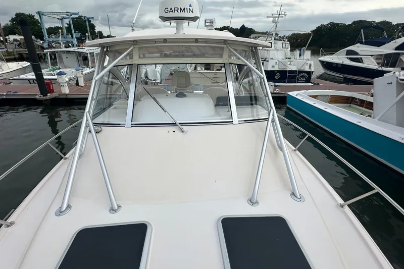 Triple Threat Yacht Photos Pics 2008 Grady-White Express 330 boat docked, featuring Garmin equipment and sleek design.