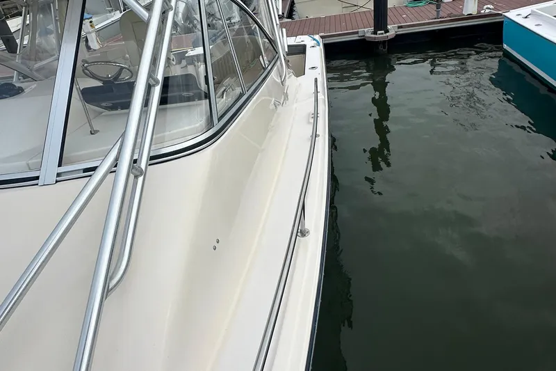 Triple Threat Yacht Photos Pics 2008 Grady-White Express 330 boat docked, showcasing sleek design and sturdy railings.