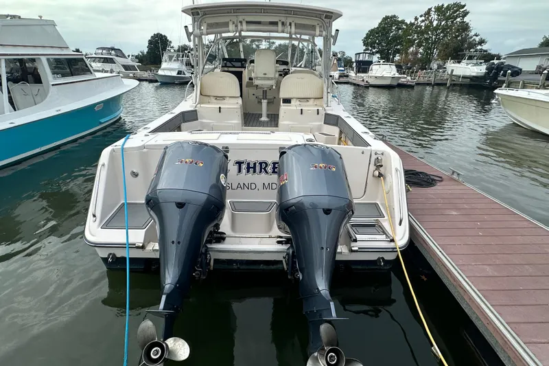 Triple Threat Yacht Photos Pics 2008 Grady-White Express 330 boat docked with twin outboard engines.
