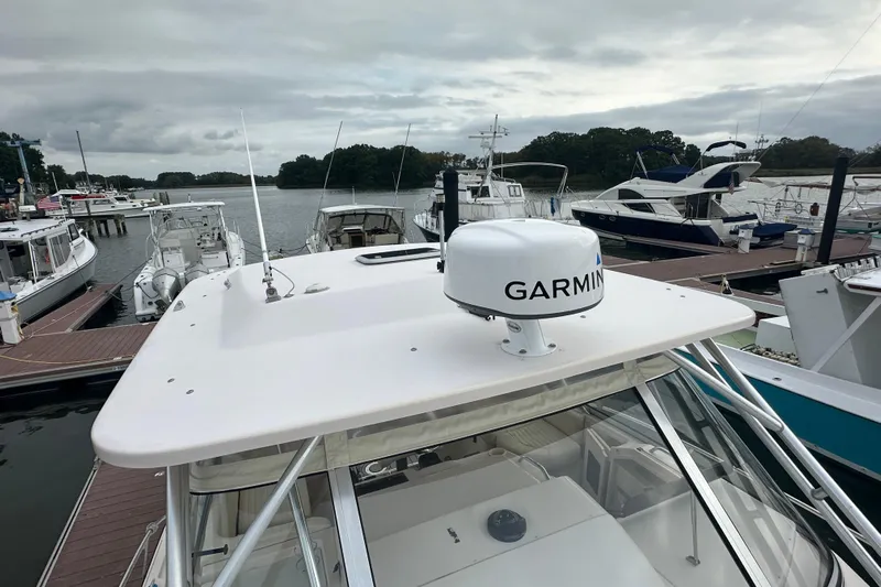 Triple Threat Yacht Photos Pics 2008 Grady-White Express 330 boat docked, featuring Garmin radar, surrounded by other boats.