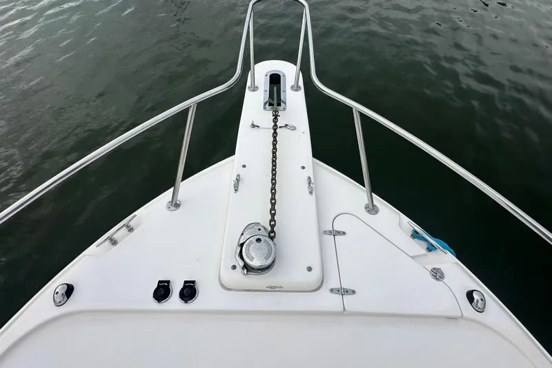 Triple Threat Yacht Photos Pics Bow of 2008 Grady-White Express 330 boat with anchor chain and railing.