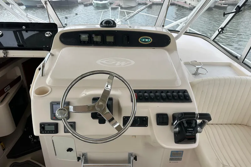 Triple Threat Yacht Photos Pics Helm of 2008 Grady-White Express 330 boat with steering wheel and controls.