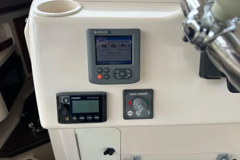 Triple Threat Yacht Photos Pics Control panel of a 2008 Grady-White Express 330 boat with navigation and audio systems.