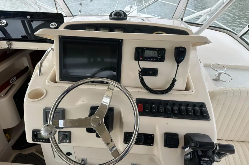 Triple Threat Yacht Photos Pics 2008 Grady-White Express 330 helm with steering wheel, controls, and navigation equipment.