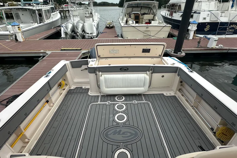 Triple Threat Yacht Photos Pics 2008 Grady-White Express 330 boat interior at dock, featuring spacious deck and seating.